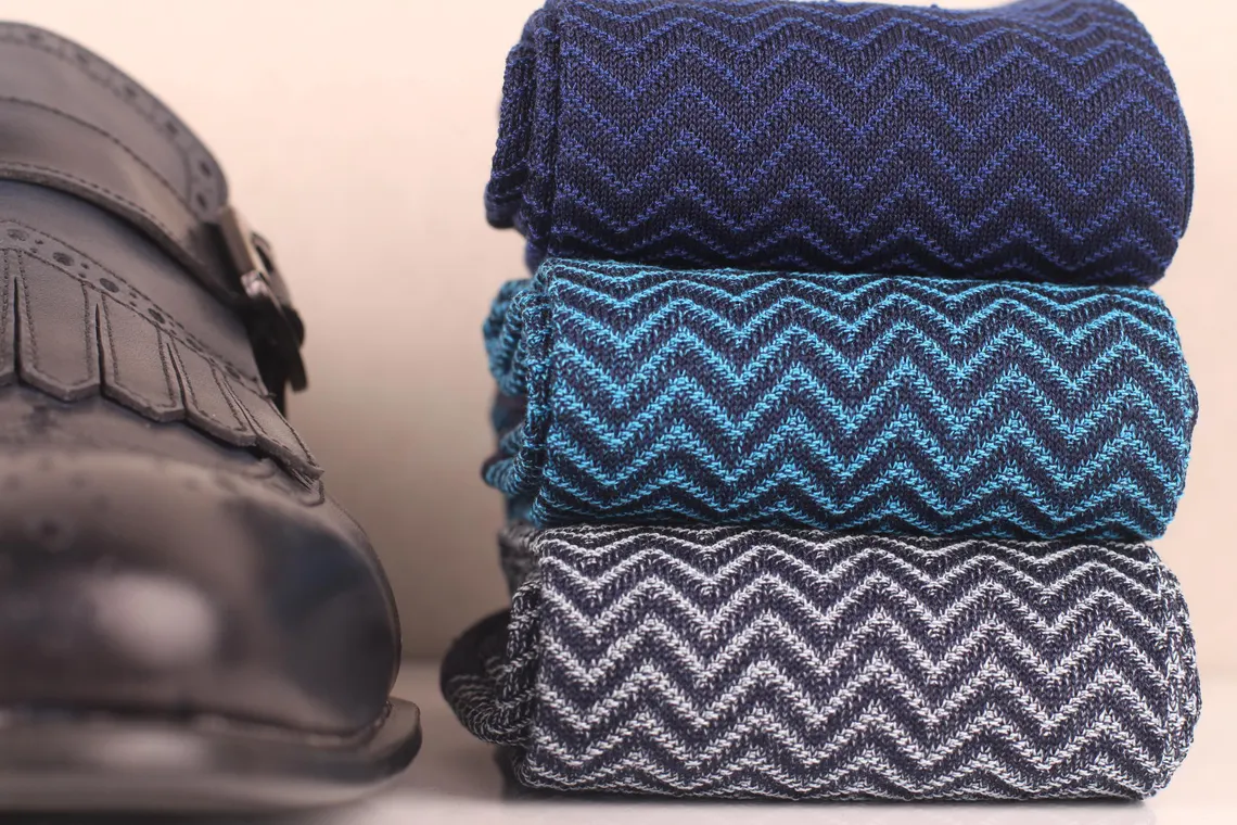 close up of navy blue ribbed cotton socks texture detail